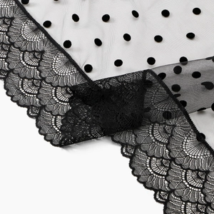 Close-up of black floral lace trim with polka dot mesh veil for wedding bridal accessories
