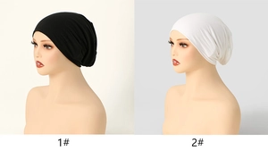 Detail view of black and white mercerized cotton beanies for women showing fabric texture