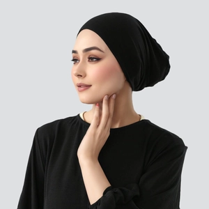 Close-up of a black mercerized cotton hijab undercap showing smooth texture and snug fit