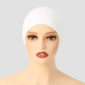 Detailed close-up of a white mercerized cotton flat top turban hat with elastic fabric