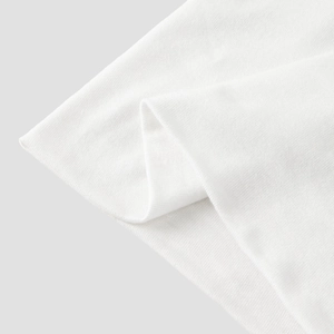 Close-up of white mercerized cotton fabric showing fine knitted texture and soft touch