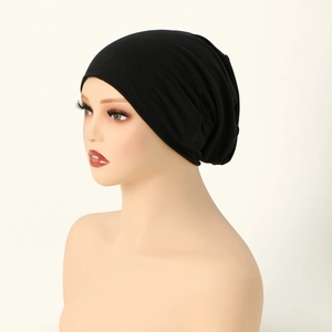 Detail view of a black mercerized cotton turban cap with premium breathable fabric texture