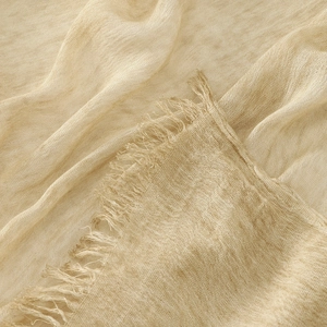 Beige crinkle cotton scarf featuring fine woven texture and handcrafted tassel fringe