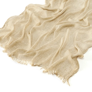 Beige crinkled cotton shawl with textured fold design and frayed tassel edges on white