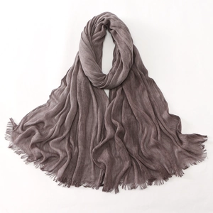 Detail view of dark grayish purple crinkle scarf with soft texture and frayed edges