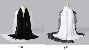 Detail of elegant solid color long scarves with delicate lace borders in black and white