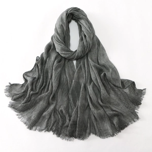 Close-up of gray textured hijab with fine pleated fabric and delicate frayed edges