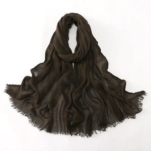 Detail of dark brown long hijab showing soft pleated texture and delicate raw fringe edges