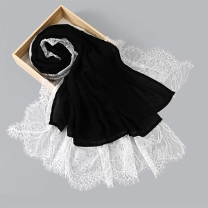 Black long scarf with white eyelash lace trim for women displayed in a wooden box