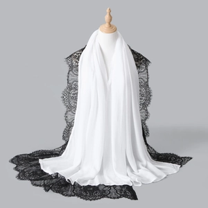 Detail of white chiffon shawl featuring exquisite black eyelash lace embroidery border