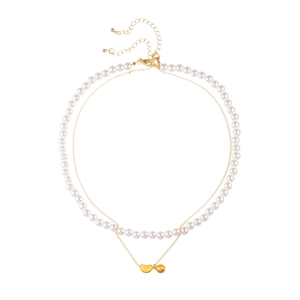 Elegant double-layered gold chain necklace with round white pearls and bean pendant