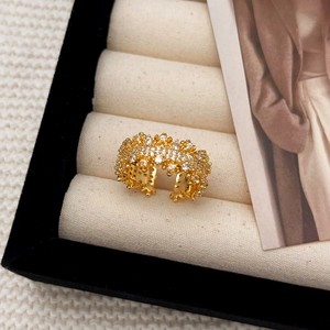 Elegant gold-tone wide open ring with micro-paved sparkling crystals on beige velvet tray