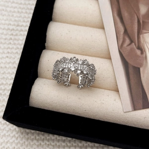 Detailed view of irregular silver ring with pavé crystals on a black velvet display