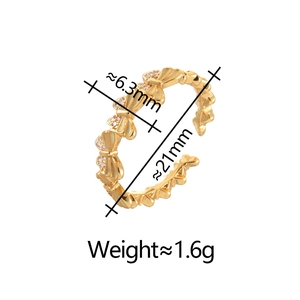 Macro detail of gold butterfly bow ring showing width dimensions and pavé zircon settings