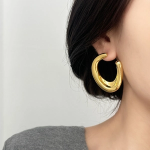 Statement C-shaped gold hoop earrings with a chunky sculpted design for women