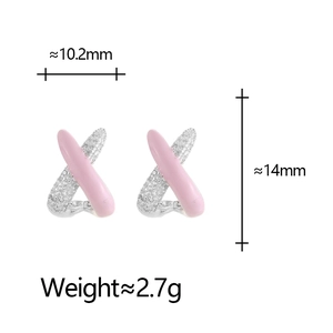Detail shot of X-shaped cross earrings with pink enamel and pavé cubic zirconia