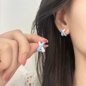 Elegant silver X-cross stud earrings with blue enamel and sparkling pavé crystals