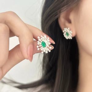 Irregular flower bud stud earrings with green gemstone and beaded radial design