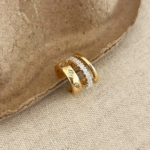 Detailed view of gold-plated triple layer ear cuff with cubic zirconia pavé setting