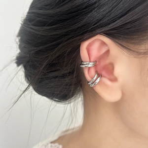 Minimalist silver double-layered ear cuff clips shown on a female model