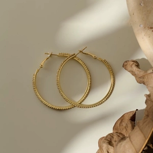 Chic gold hoop earrings with textured pave crystal grid design for a luxury style