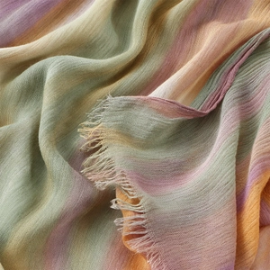 Rainbow striped crinkle scarf with soft pastel hues and frayed tassel edges