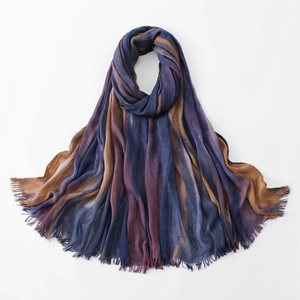 Detail of colorful rainbow pleated scarf with fringe edge in striped ethnic style