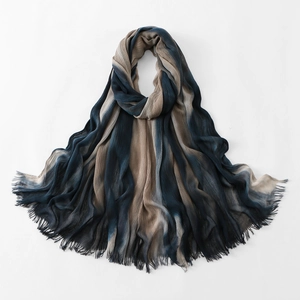 Detailed view of tie-dye gradient pleated scarf with fringed edges and crinkled texture