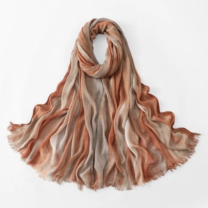 Detailed view of pleated cotton scarf featuring gradient stripes and fringed edges