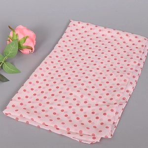 Detail of pink chiffon scarf with red polka dots and delicate stitched edge finish