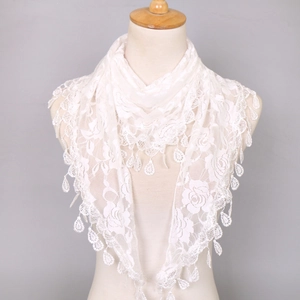 Detail of white lace triangle scarf featuring intricate floral patterns and drop tassels