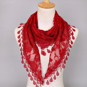Macro detail of red lace triangle scarf with floral patterns and teardrop pendants