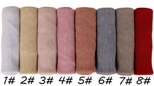 Detail of thin ribbed scarves in eight colors featuring shimmering golden metallic threads