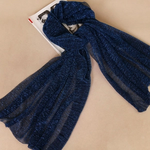 Detail of dark blue scarf with metallic gold threads and semi-transparent mesh texture