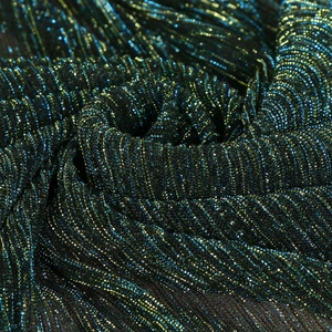 Detail of emerald green and blue gradient fabric with metallic shimmer and pleats