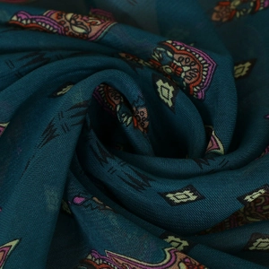 Detailed view of peacock blue chiffon scarf featuring ethnic geometric patterns and textures
