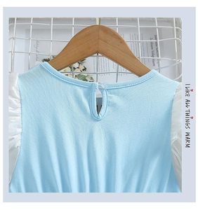 Détail d'une robe bleu clair pour filles avec col rond et volants blancs aux manches
