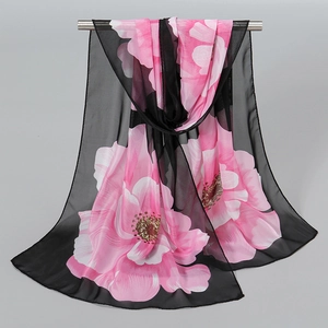 Breathable black chiffon scarf with large pink floral print on a metal hanger