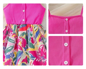 Close-up of girls' dress showing pink ribbed top with floral mesh layered skirt details