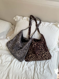 Detail showing corduroy leopard print tote bags in black-white and classic brown patterns