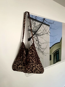Detailed view of leopard print corduroy hobo bag showing soft texture and spacious design