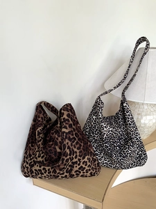 Detail of two leopard print corduroy tote bags with different textures on a shelf