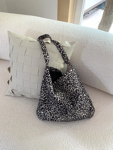 Close-up of leopard print corduroy tote bag showing fabric texture and shoulder strap