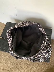 Close-up of leopard print tote bag interior showing large capacity and black lining