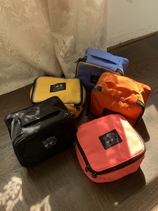 Set of five colorful nylon travel cosmetic bags featuring bear patches and sturdy handles