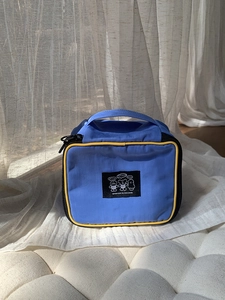 Blue nylon travel pouch with contrast yellow trim and cute cartoon animal design