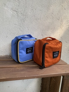Detail view of nylon travel organizer bags with top handles and cute bear patches