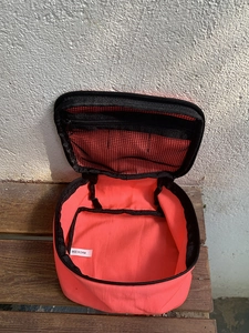 Macro view showing the interior mesh zipper pocket of the coral nylon makeup bag