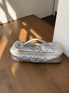 Silver heart-quilted storage bag for hair dryer and styler with top handle and zipper