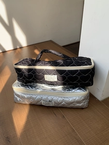 Quilted travel organizers for hair tools in black and silver with heart stitching